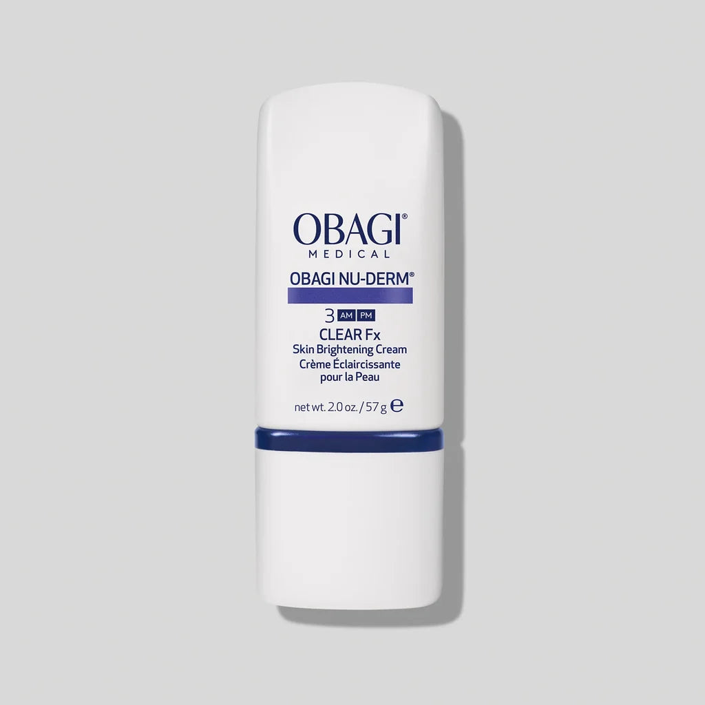 A white cylindrical bottle of Obagi Medical Obagi Nu-Derm Clear Fx Skin Brightening Cream, featuring blue text and a blue band, set against a solid light gray background.