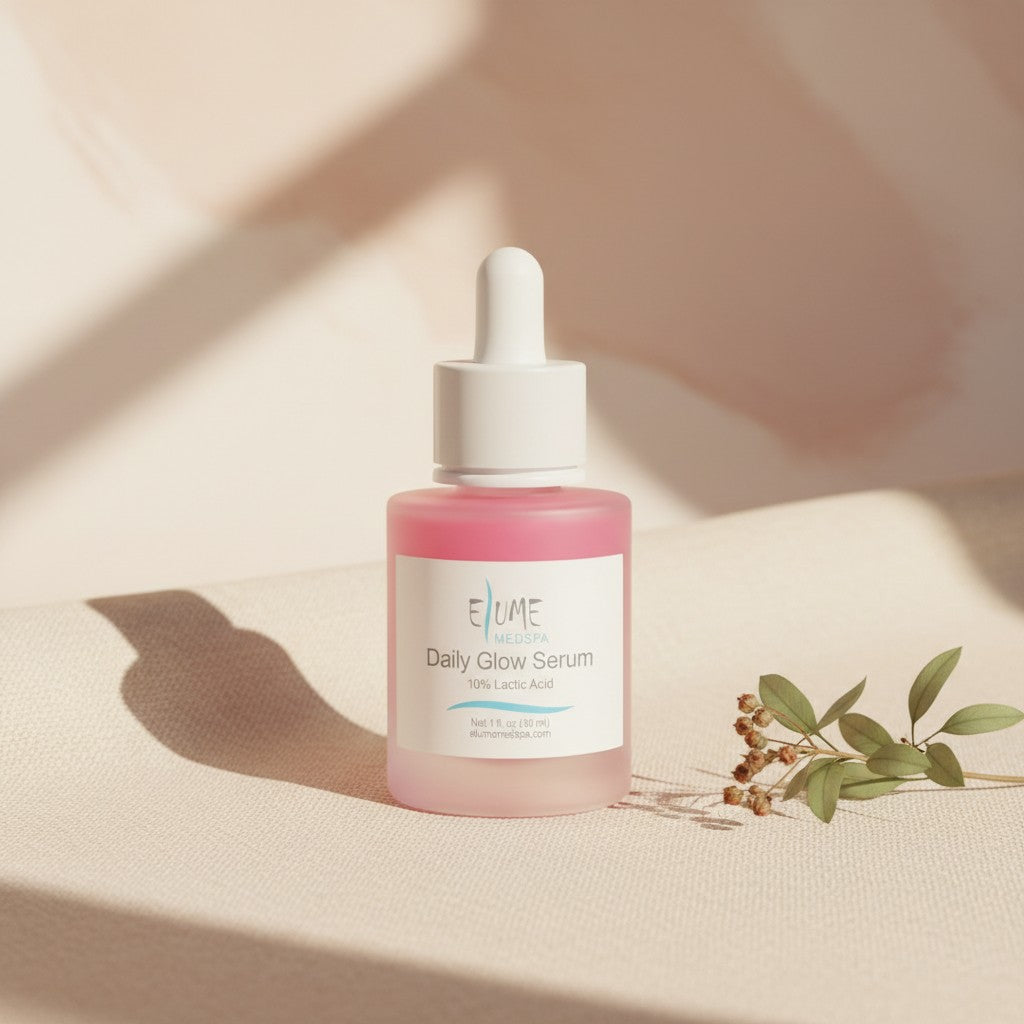 Elume Medspa Lactic Acid Resurfacing Serum in a pink glass dropper bottle on a neutral background with dried leaves.