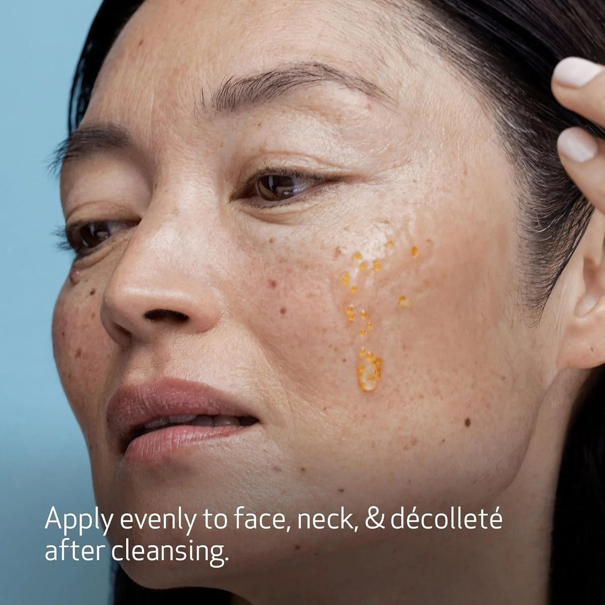 Close-up of a person's face with visible skin texture and text overlay on a blue background