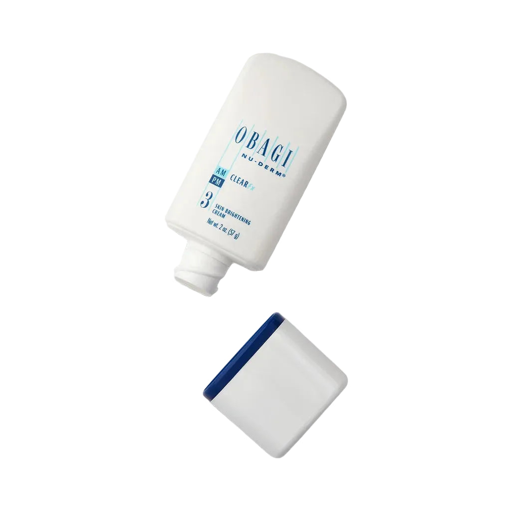 A white Obagi Clear PM sunscreen bottle with blue text, shown with its cap off on a light gray background.
