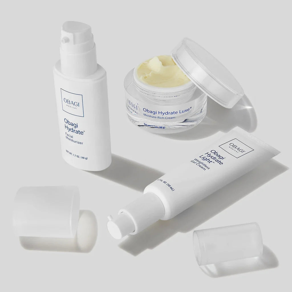 Obagi skincare products including a bottle, jar, and cream on a light gray background
