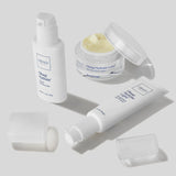 Obagi skincare products including a bottle, jar, and cream on a light gray background