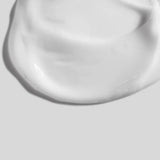Close-up of a smooth, white ceramic bowl on a matching background