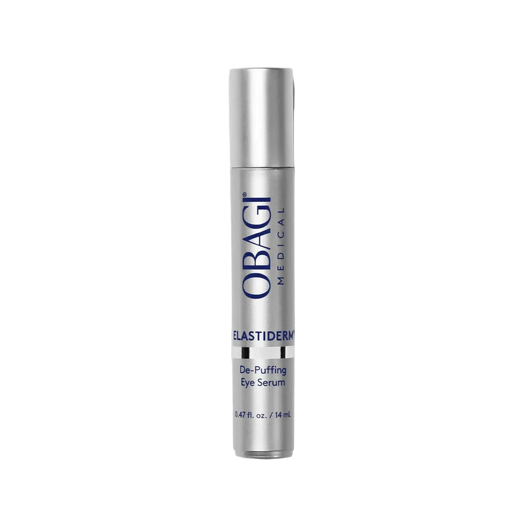 A silver cylindrical bottle of OBAGI MEDICAL Elastiderm De-Puffing Eye Serum, standing vertically against a solid light gray background.