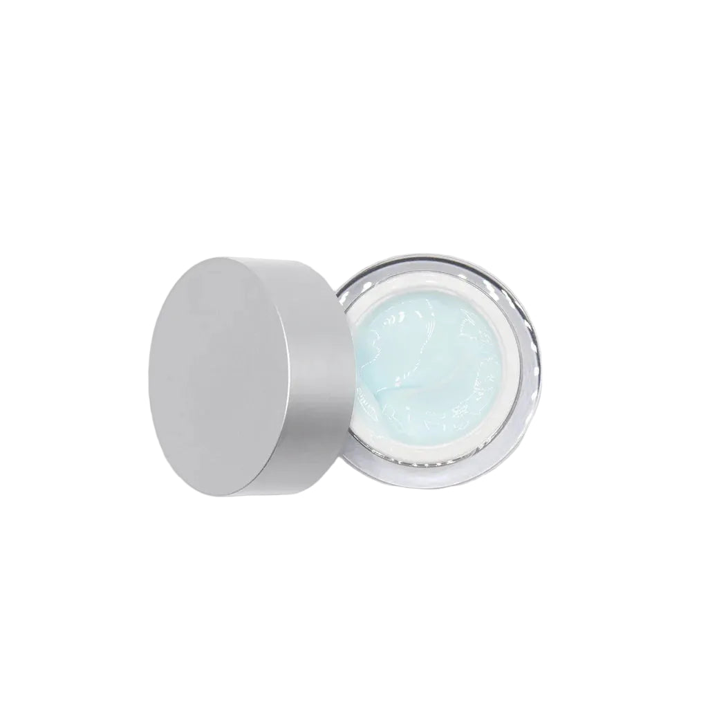 Cosmetic cream jar with silver lid on a light gray background