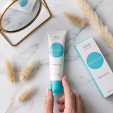 Elume Med Spa Obagi360 Retinol 0.5 cream tube and box on a marble surface with dried grass and a mirror reflection.