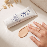 Elume Med Spa SUZANOBAGIMD Tinted Physical Defense SPF 50 mineral sunscreen tube with a swatch of tinted cream