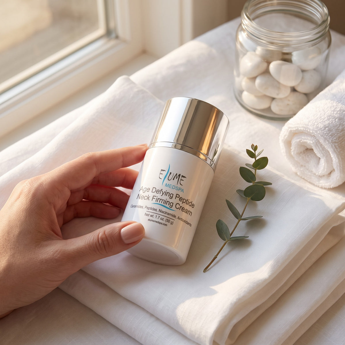 Elume peptide neck cream on a marble ledge as part of a daily anti-aging skincare routine